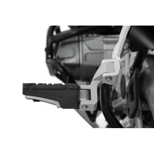 Passenger footrest relocation